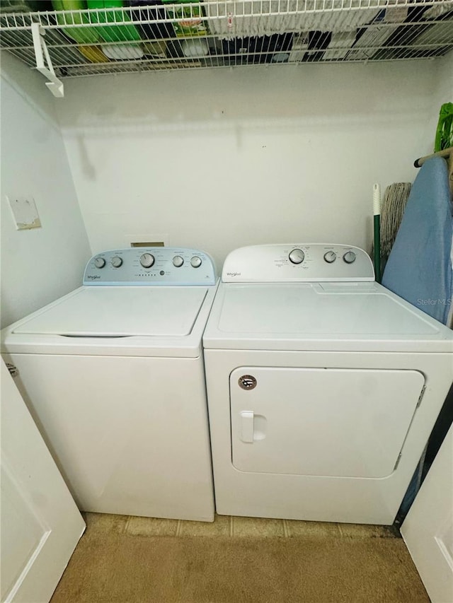 washroom with washer and clothes dryer and carpet