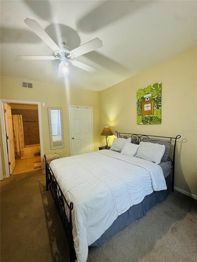 bedroom featuring ceiling fan and dark carpet