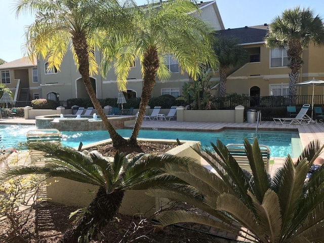 view of pool with a patio area and pool water feature