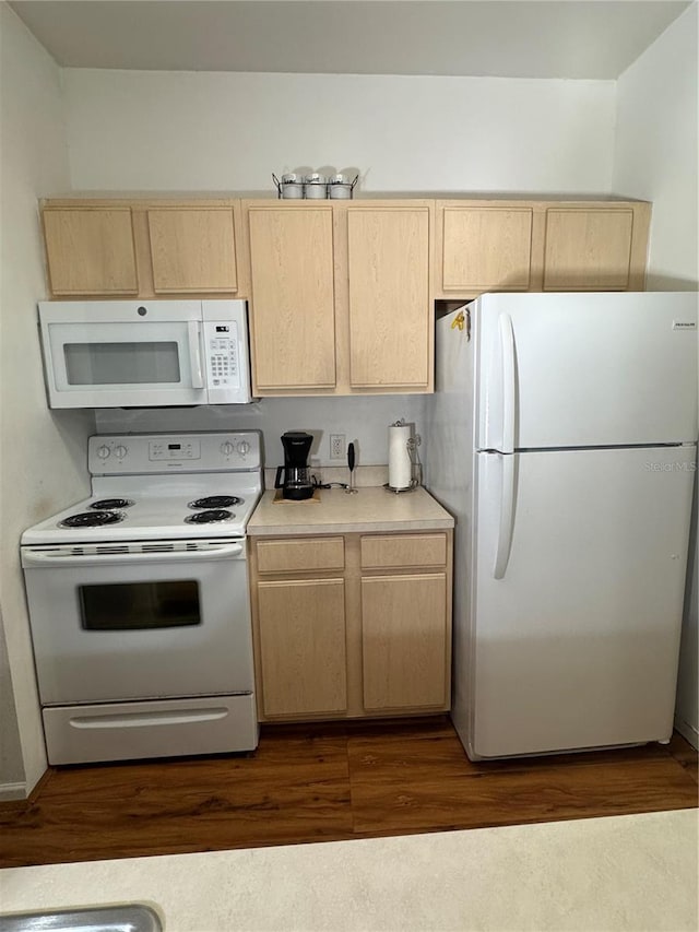 kitchen featuring dark hardwood / wood-style floors, white appliances, and light brown cabinetry