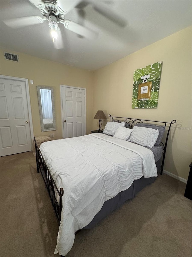 bedroom with ceiling fan and dark carpet