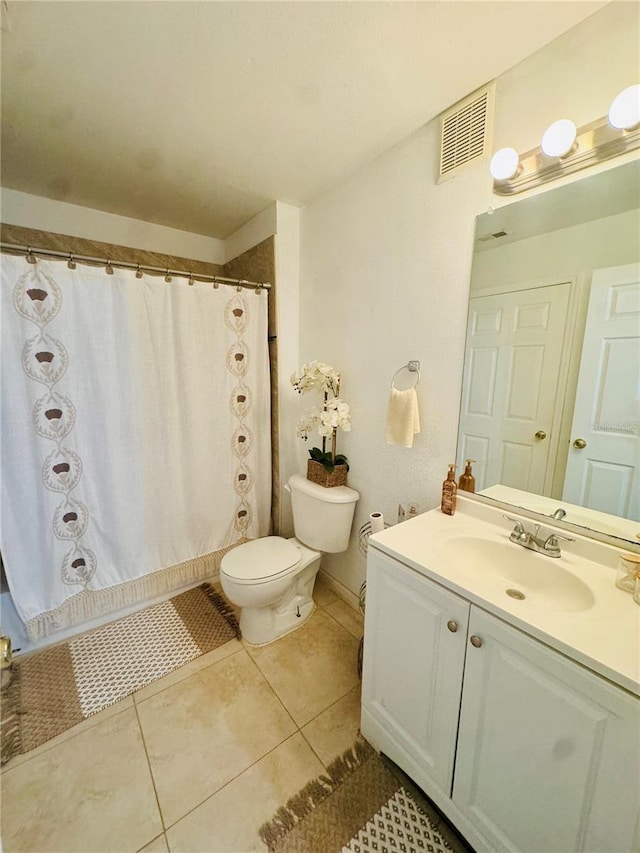 bathroom featuring tile patterned floors, vanity, and toilet