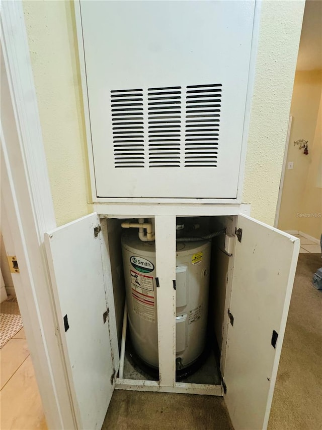 utility room featuring water heater