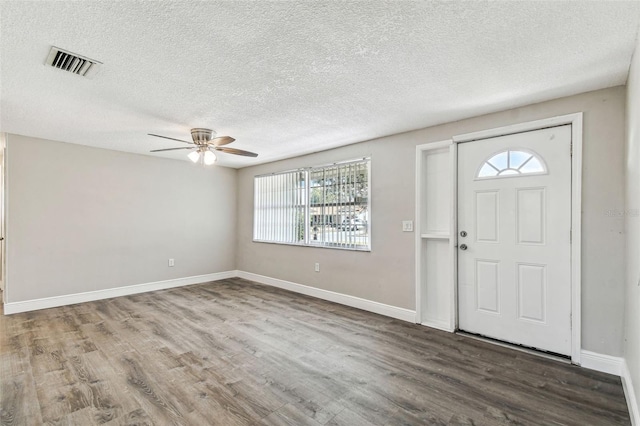 foyer featuring hardwood / wood-style floors, ceiling fan, and a textured ceiling