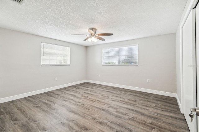 interior space with ceiling fan, wood-type flooring, and a textured ceiling