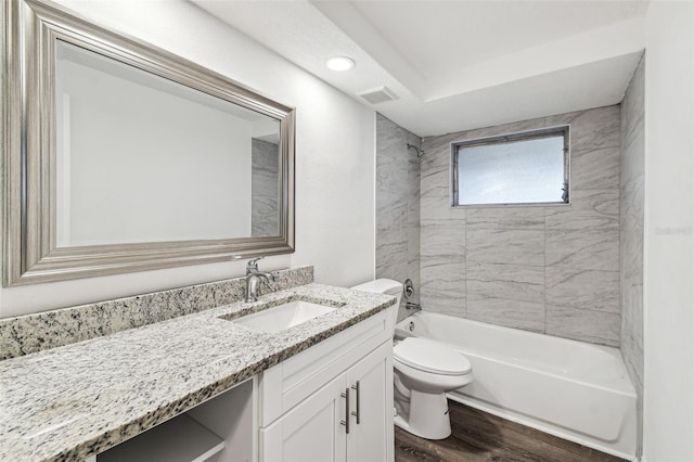 full bathroom with hardwood / wood-style floors, vanity, toilet, and tiled shower / bath combo