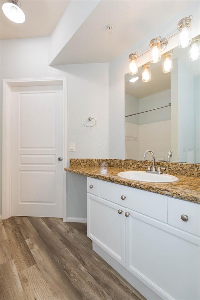 bathroom featuring hardwood / wood-style floors and vanity