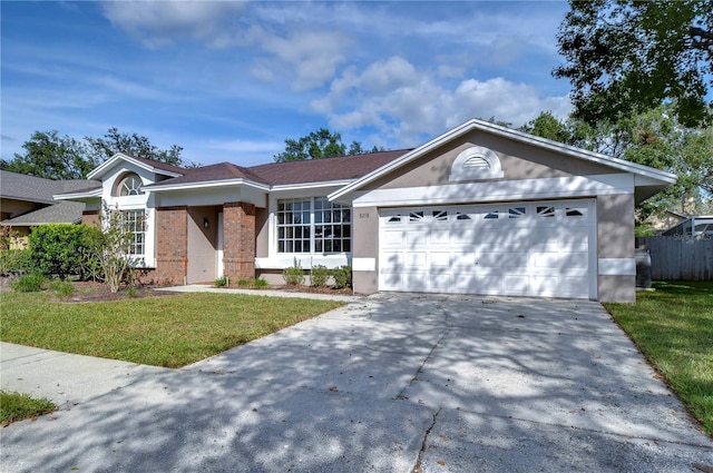 ranch-style home with a garage and a front lawn