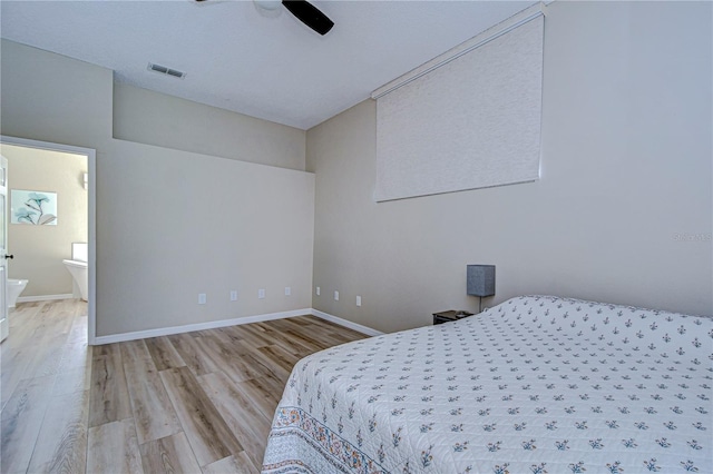 bedroom with connected bathroom, a textured ceiling, ceiling fan, and light hardwood / wood-style flooring