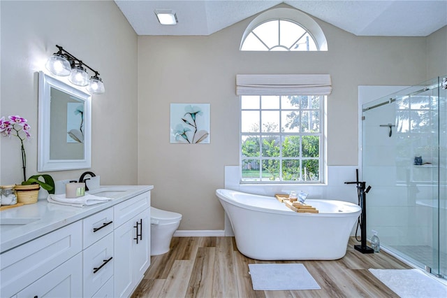 full bathroom with toilet, hardwood / wood-style floors, a textured ceiling, vanity, and independent shower and bath