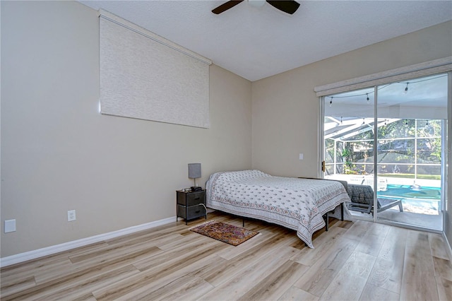 bedroom with light hardwood / wood-style flooring, a textured ceiling, ceiling fan, and access to exterior