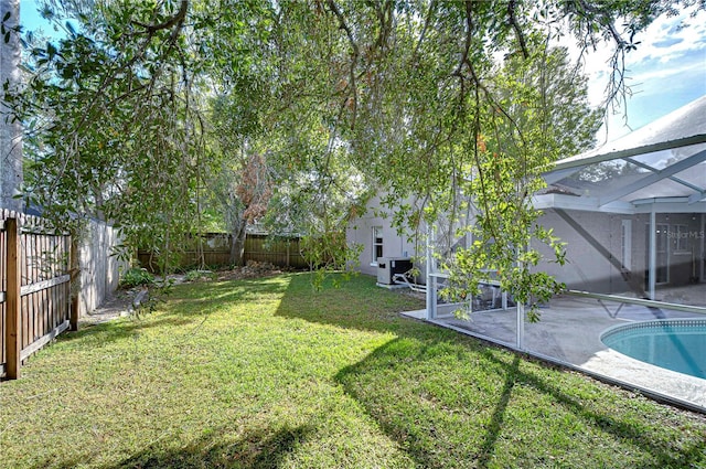 view of yard featuring a lanai, a fenced in pool, and a patio area