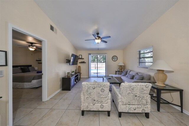 tiled living room with ceiling fan and vaulted ceiling