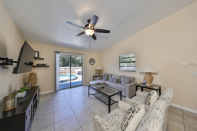 living room with lofted ceiling, light tile patterned floors, and ceiling fan