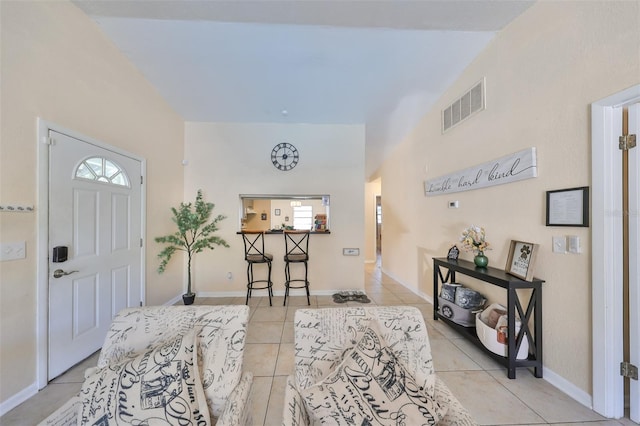 tiled entrance foyer with vaulted ceiling