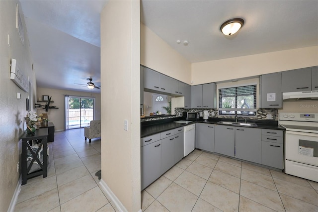 kitchen featuring gray cabinetry, white appliances, sink, and a healthy amount of sunlight