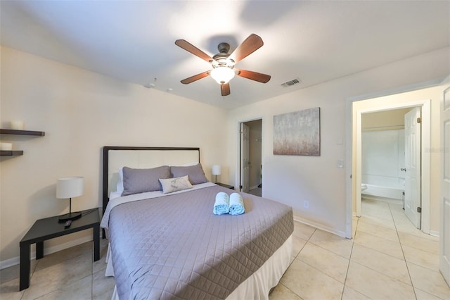 tiled bedroom with ensuite bathroom and ceiling fan