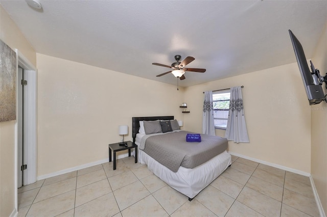 tiled bedroom featuring ceiling fan