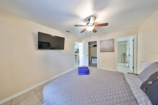 unfurnished bedroom featuring light tile patterned floors, ceiling fan, and connected bathroom