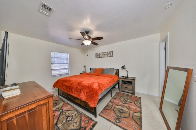 tiled bedroom featuring ceiling fan