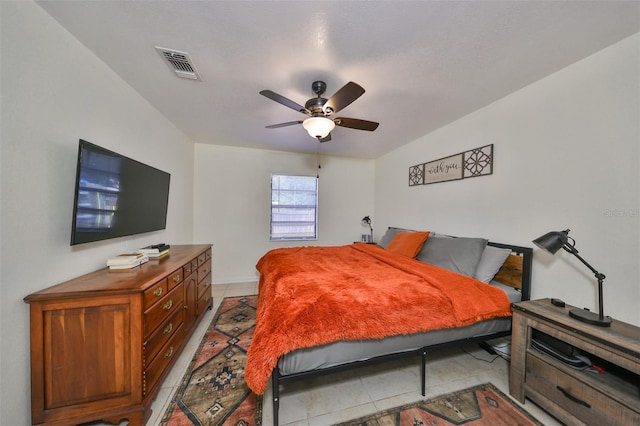 tiled bedroom with ceiling fan