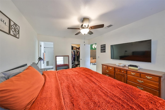 bedroom with a closet, a walk in closet, and ceiling fan