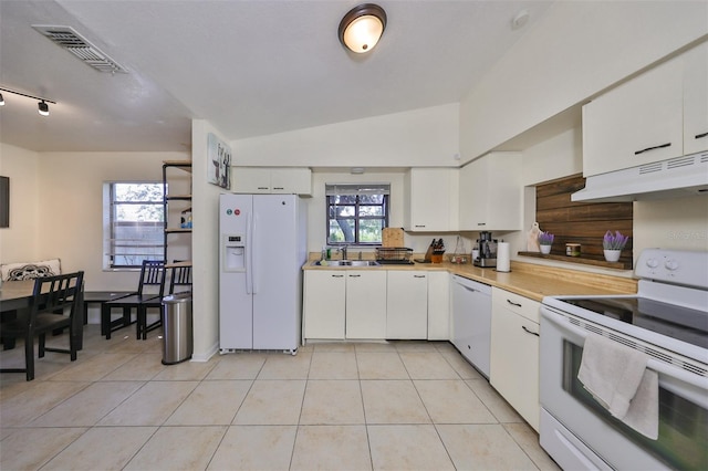 kitchen with white cabinets, white appliances, plenty of natural light, and vaulted ceiling