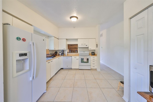 kitchen featuring white appliances, white cabinetry, and light tile patterned flooring