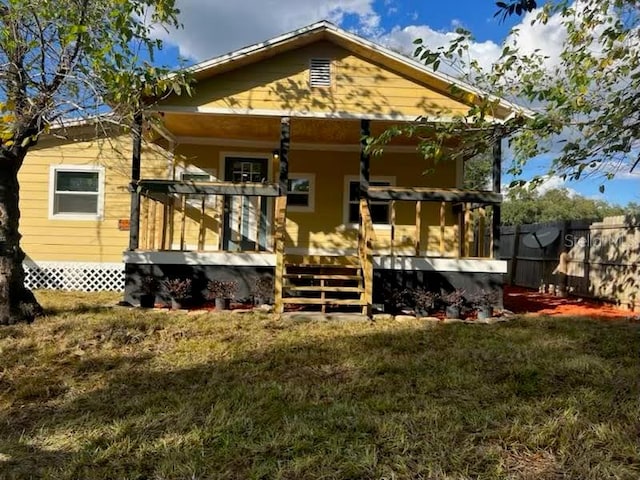 back of house featuring a yard and a deck