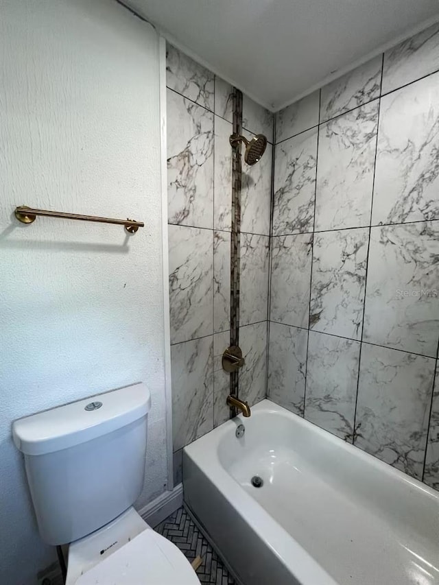 bathroom featuring toilet and tiled shower / bath combo