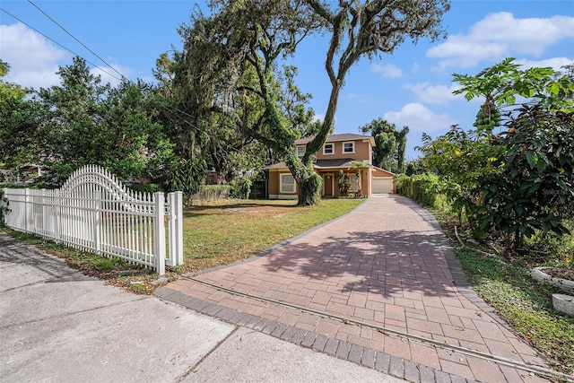 view of front of home featuring a garage and a front yard