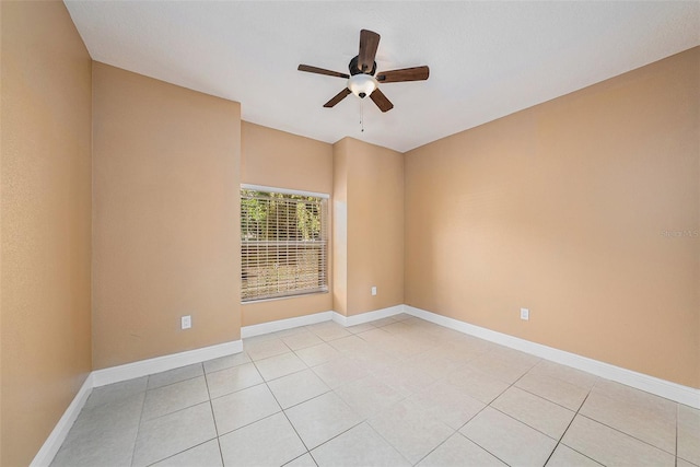 tiled spare room featuring ceiling fan