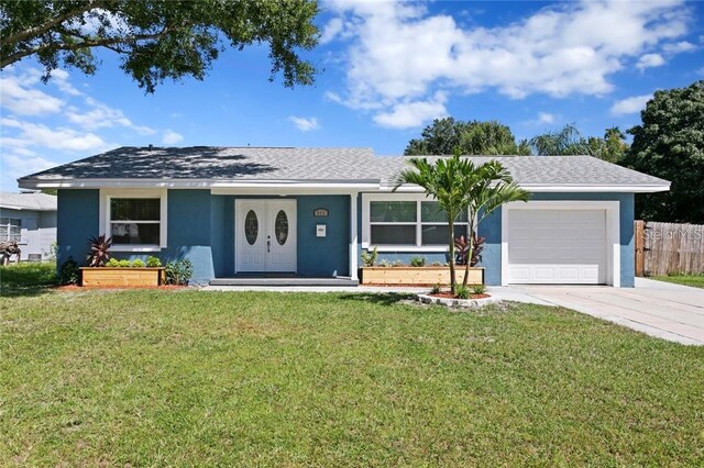 ranch-style home with a garage, a front lawn, and a porch