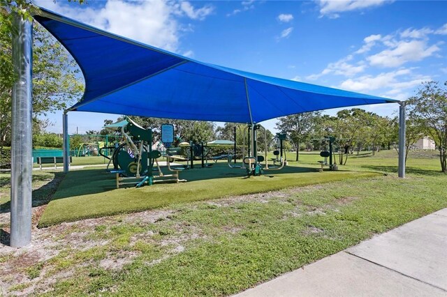 surrounding community featuring a playground and a yard