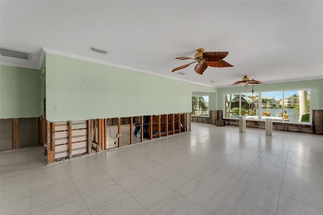 tiled empty room with crown molding, visible vents, and a wealth of natural light