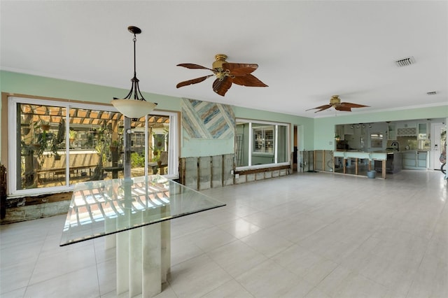 unfurnished living room featuring visible vents and ceiling fan