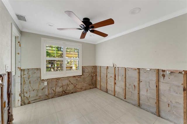 unfurnished room with ornamental molding, wainscoting, visible vents, and a ceiling fan