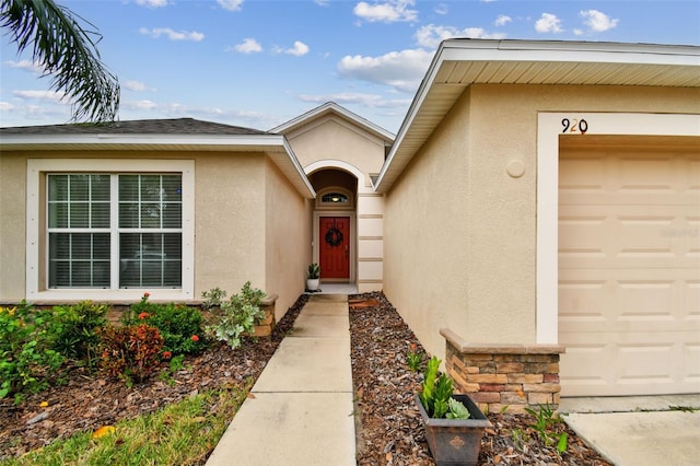 view of exterior entry with a garage