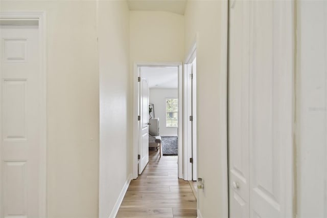 hallway with light hardwood / wood-style floors