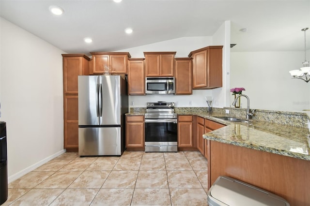 kitchen with stainless steel appliances, sink, light stone countertops, pendant lighting, and vaulted ceiling