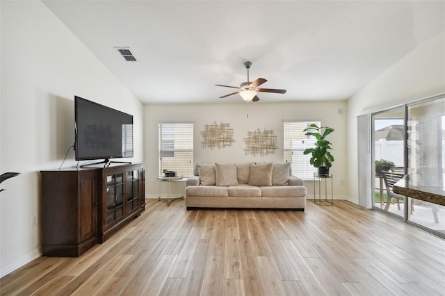 living room featuring a wealth of natural light and light hardwood / wood-style flooring