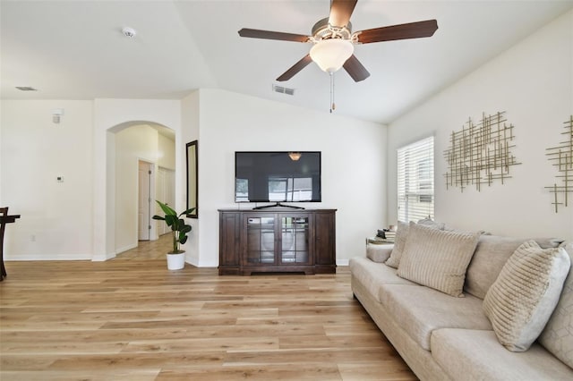 living room featuring ceiling fan, lofted ceiling, and light hardwood / wood-style floors