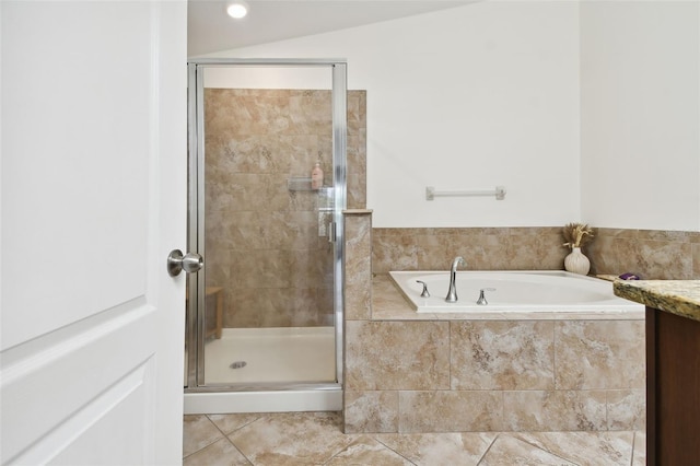 bathroom featuring tile patterned flooring, independent shower and bath, vanity, and vaulted ceiling