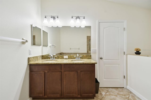 bathroom featuring vanity, tile patterned floors, and vaulted ceiling