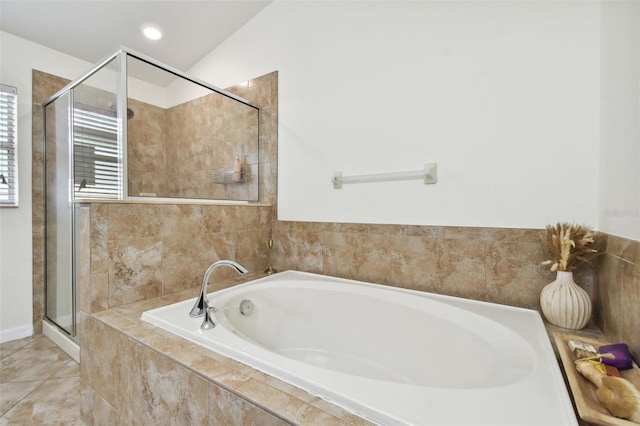 bathroom featuring independent shower and bath, vaulted ceiling, and tile patterned floors