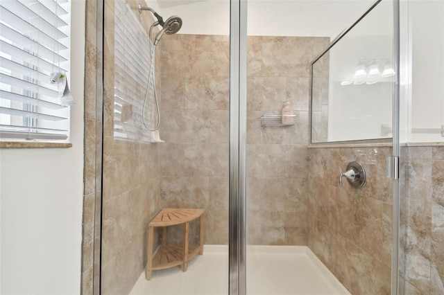 bathroom featuring a shower with shower door