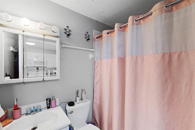 bathroom featuring vanity, curtained shower, a textured ceiling, and toilet