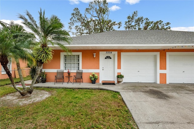 ranch-style home featuring a garage, a front yard, and a porch