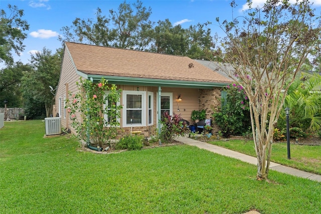 view of front of property featuring central air condition unit and a front yard