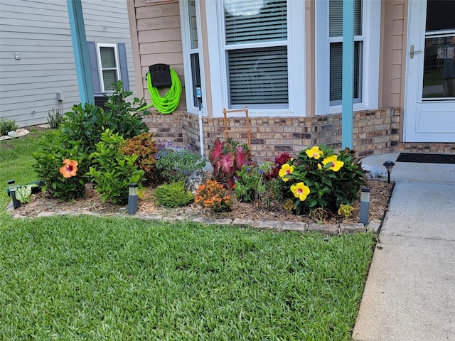 entrance to property featuring a lawn